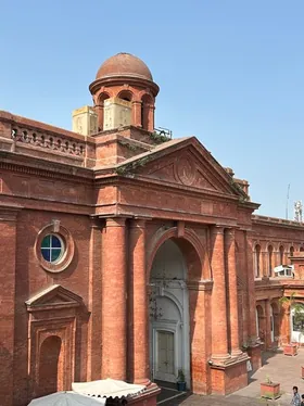 The restored red-brick facade and arched colonnades of a century-old college campus