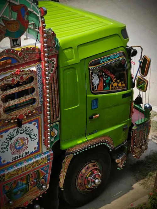 Detail of a colorfully painted truck covered in ornamental floral designs